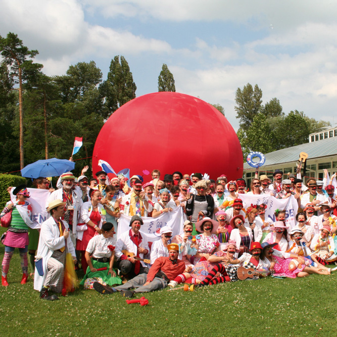 Large group of clowns in a garden